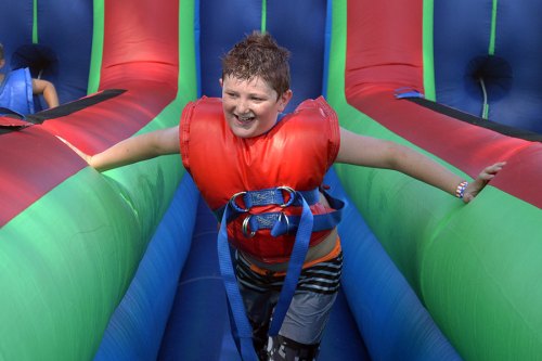 Nathaniel Long seems to be enjoying his romp on one of many events during Wednesday's Fourth of July Celebration in Lemoore City Park.